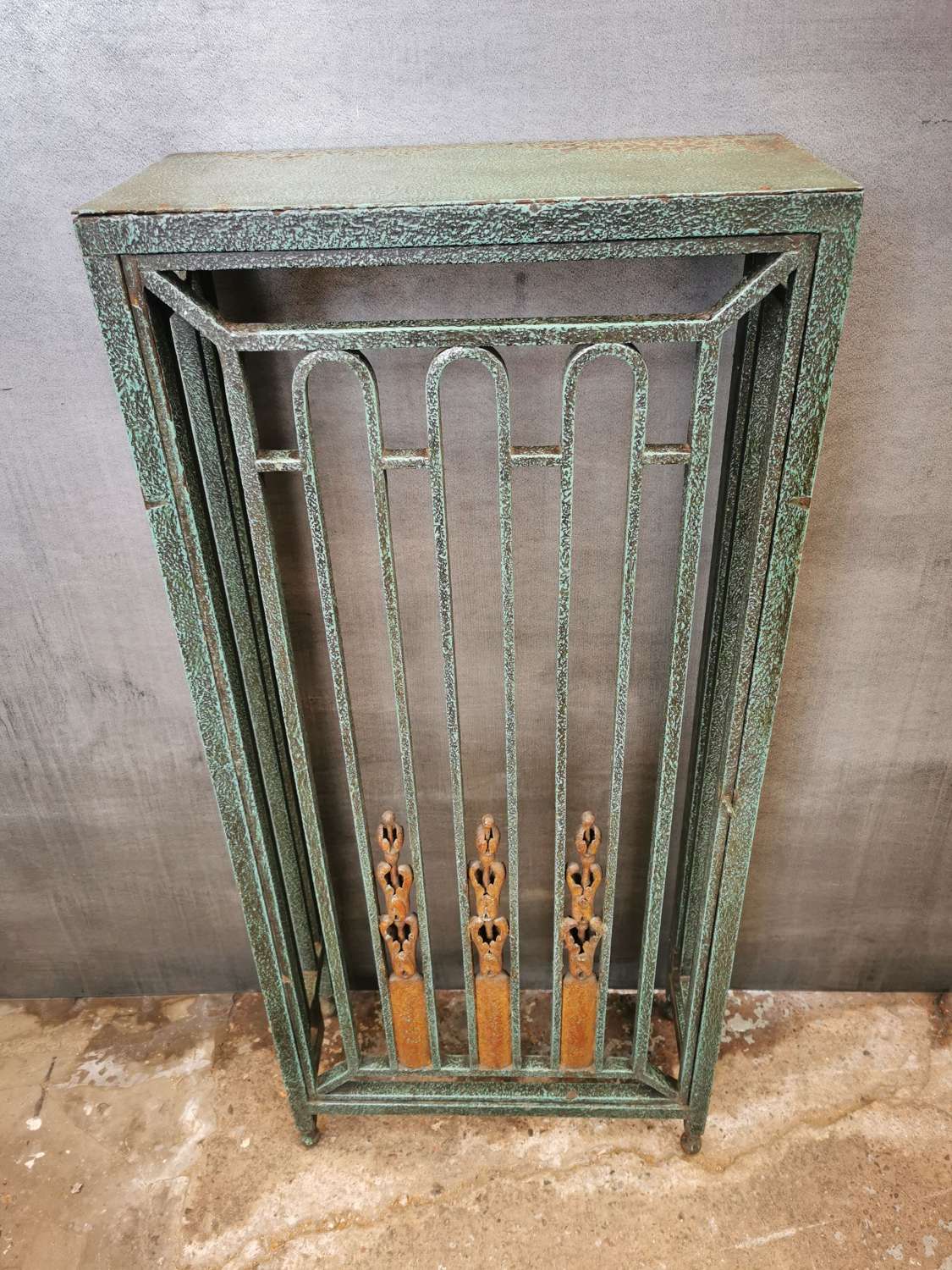An early 20th century or late 19th green enamel painted radiator cover